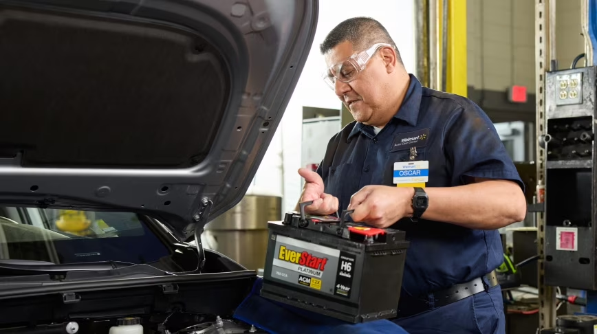 Technician at Walmart doing battery installation